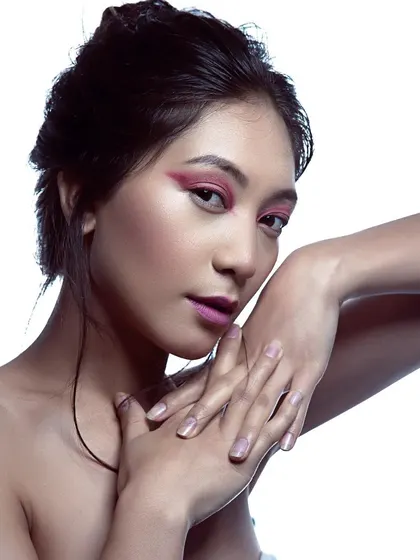 Experimenting with color is my favorite part of editorial makeup. Here, I used a bold pink graphic eyeliner to create a high-fashion, artistic look, balanced with a soft, messy updo.