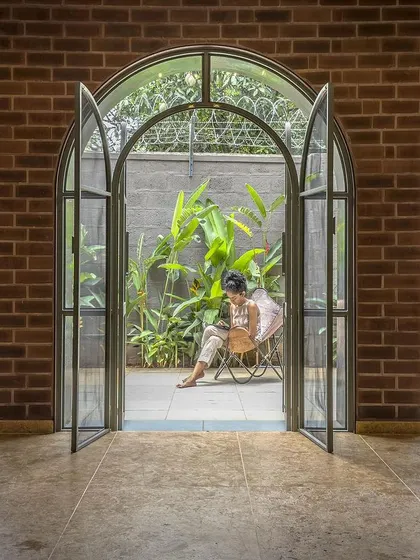Looking from the inside out, the arched doors perfectly frame the view of the courtyard garden. This creates a peaceful and picturesque backdrop for the interior living spaces.