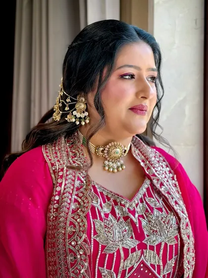 A beautiful look for a 'Myrah' function, with a bright pink outfit and soft, glowing makeup.