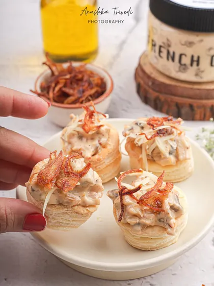 Mini vol-au-vents filled with the French onion dip, showcasing a creative and elegant serving suggestion.