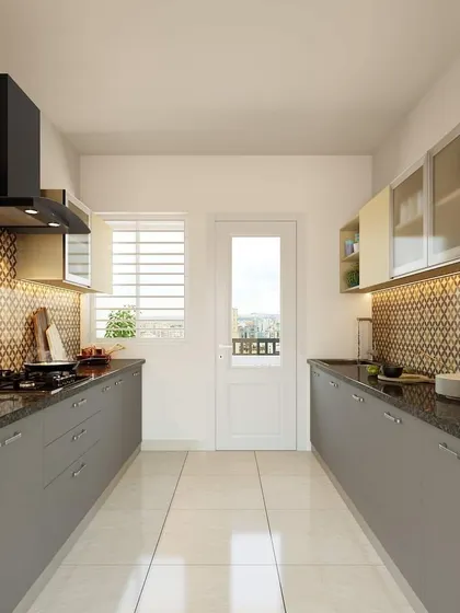 Another angle of the parallel kitchen, showing the efficient use of space. The patterned backsplash with warm under-cabinet lighting adds a touch of personality and style.