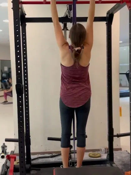 A snapshot from a personal training session, focusing on building upper body strength with assisted pull-ups.