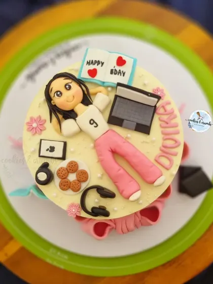 This cake is a perfect match for the birthday girl's hobbies. I created fondant versions of her laptop, headphones, cookies, and even a little book to capture her personality in edible form.