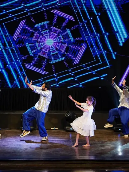 The entire group performing a graceful, synchronized move from our Bollywood act, showcasing unity and elegance.