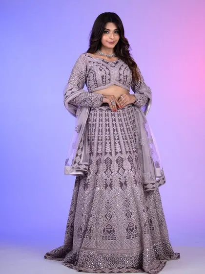 A full-length shot of the lilac lehenga, showcasing the beautiful drape of the skirt and the intricate embroidery that covers the entire outfit.