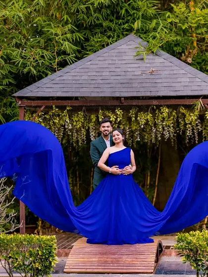A classic pose at the gazebo, with the royal blue gown spread out like wings. This shot is a client favorite, combining symmetry, vibrant color, and a beautiful natural backdrop.
