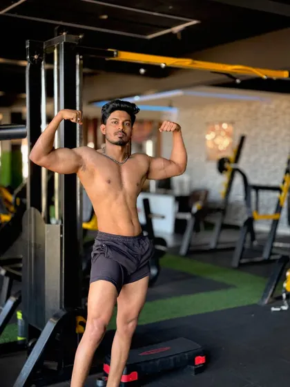 A double bicep pose in the gym. Strength comes from overcoming what you thought you couldn't.