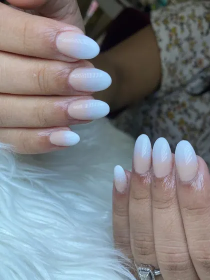 A close-up of our classic white ombre on almond-shaped nails, showcasing the flawless blend our technicians achieve.