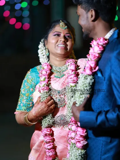 A candid shot of the couple during their reception. The bride is wearing a sparkling AD jewellery set and her smile is absolutely infectious.