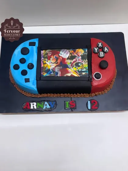 A Nintendo Switch-shaped cake, perfect for a gamer's 12th birthday. The cake is a realistic replica of the console, with a Super Mario game scene on the edible screen.