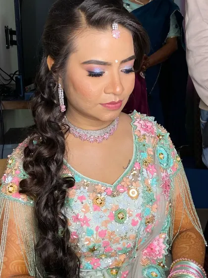 Another angle of the sangeet look, highlighting the side-swept hairstyle and the detailed embroidery on her blouse.