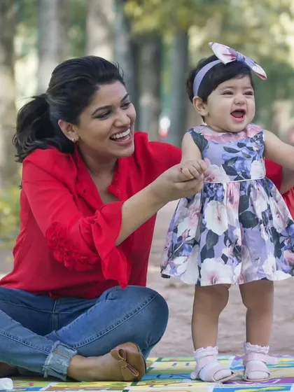 A daughter brings joyful moments to the present and hope for the future. This candid photo captures a mother and daughter sharing a moment during an outdoor park session.