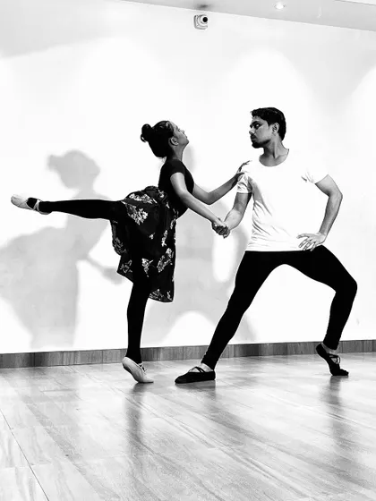 A black and white series featuring a male and female ballet dancer (ballerino and ballerina) practicing partner work. My classes include pas de deux techniques for advanced students.