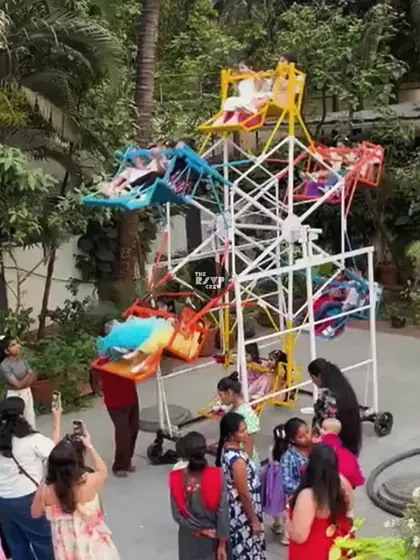 The party included a real, working mini ferris wheel for the kids to enjoy, adding to the authentic amusement park feel.
