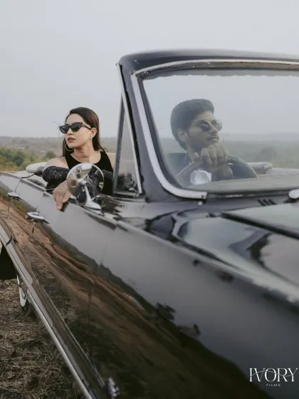 Captured through the windshield, this creative shot gives a cinematic feel to the couple's drive. Their sunglasses and relaxed poses in the vintage car perfectly suit the cool, laid-back atmosphere of Goa.