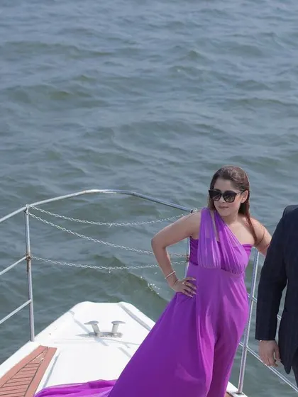 A fashionable shot of the couple on the bow of a yacht in Goa, showcasing a modern and luxurious pre-wedding experience.