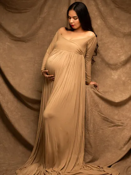 Another beautiful solo shot in a flowing beige gown. This pose exudes confidence and serenity, perfectly capturing the essence of motherhood.