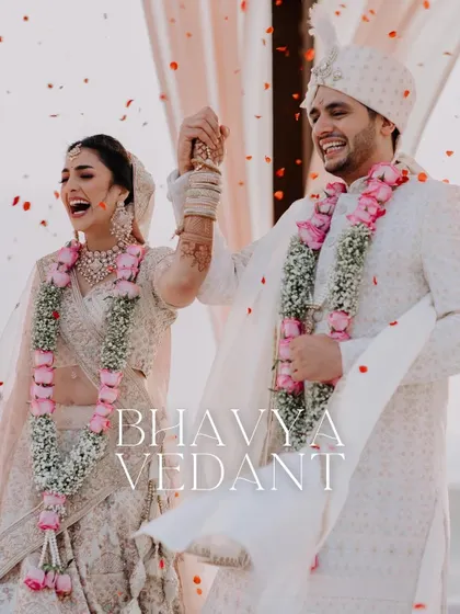 The couple celebrates with pure joy and laughter as they are showered with rose petals after their wedding ceremony.