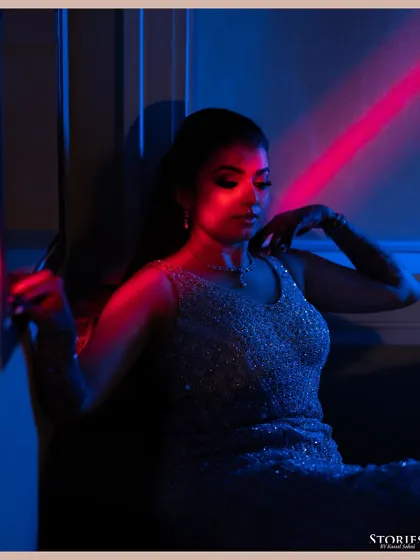 An artistic portrait of the bride, Kritika, using colored gels to create a modern and vibrant look for her cocktail party.