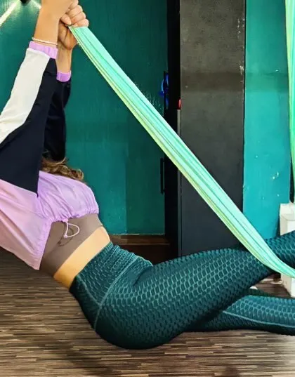 Here, I am demonstrating a suspended side plank variation using the aerial hammock. This pose intensely engages the obliques and improves balance, showing how the silks can add a new level of challenge to familiar exercises.