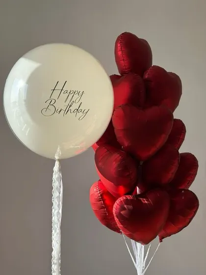 A classic and beautiful combination of red and off white. This bunch features a large personalized "Happy Birthday" balloon paired with a bouquet of red heart shaped foil balloons.