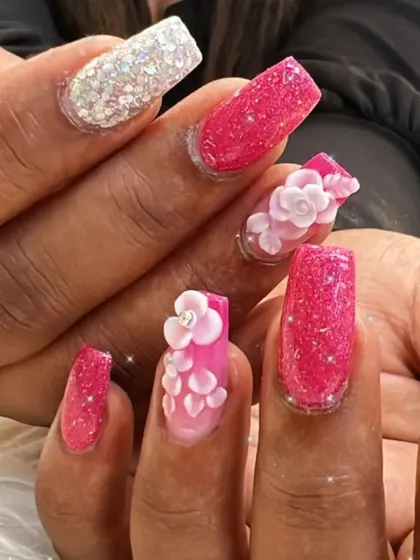 A detailed shot of the 3D flowers and glitter on square-tipped extensions. Each petal is carefully sculpted for a realistic and beautiful effect.