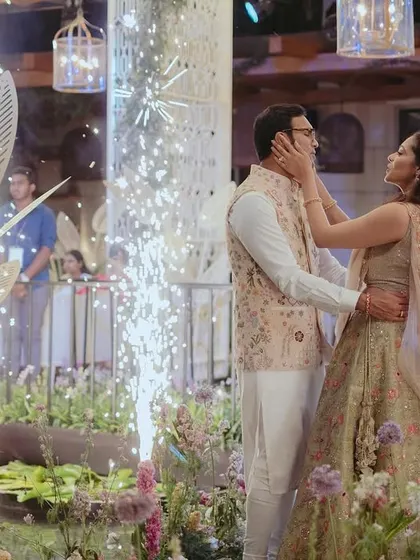 The couple shares a beautiful moment surrounded by sparklers at their Mehendi sundowner. The custom floating island and floral decor created an enchanting backdrop for their celebration.