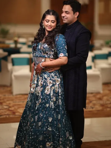 Another beautiful portrait of the couple, showcasing their coordinated outfits against the backdrop of the event hall. We ensure the overall ambiance is perfect for photography.
