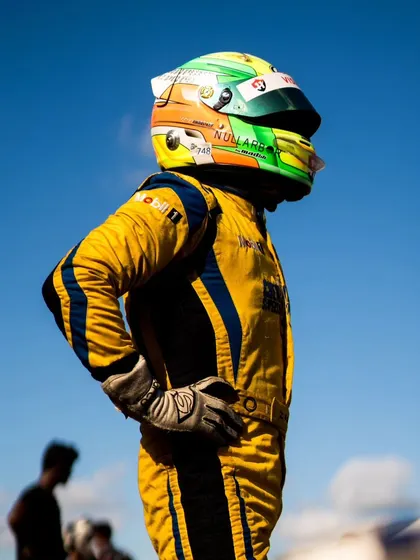 A driver stands on the track, reflecting on the race. Every weekend is a rollercoaster, and we embrace the ups and downs as part of the journey.