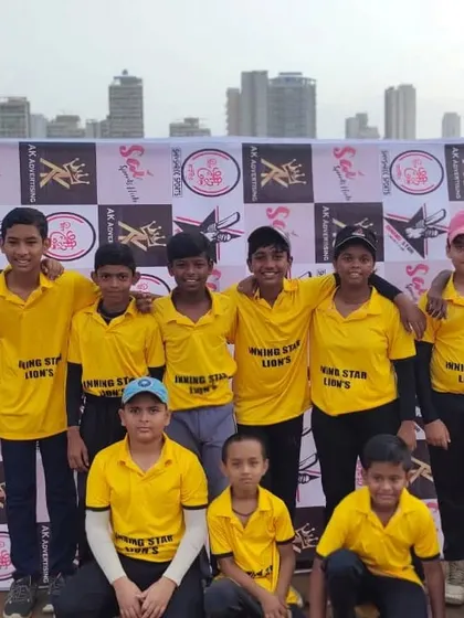 The Inningstar Lions junior team posing for a photo in front of the event banner.