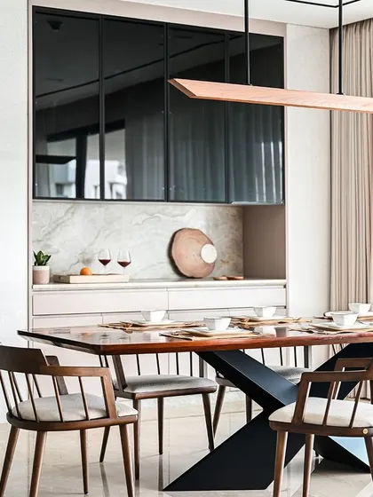 The dining area includes a sleek, modern crockery unit with tinted glass shutters and a marble backsplash, providing stylish and practical storage.