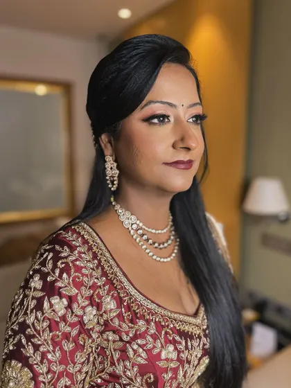 A side profile of the reception look. The makeup is designed to look beautiful from every angle, with a focus on a seamless blend and a radiant finish.