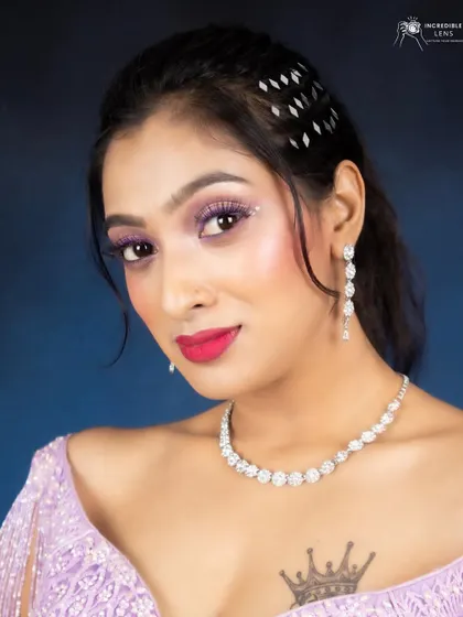 A close-up portrait of the lilac makeup look. The eyes are adorned with a touch of glitter for a festive feel.