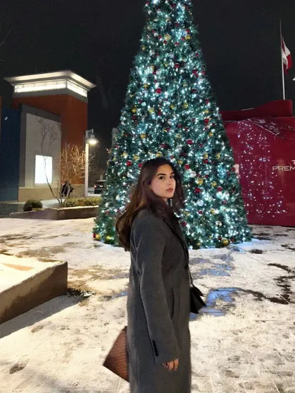A portrait shot with the beautiful Christmas tree lights in the background.