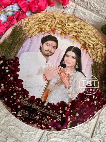 For this 12-inch round frame, I preserved a client's engagement bouquet. The design features an arch of wheat and grass over the photo, with red petals at the base.
