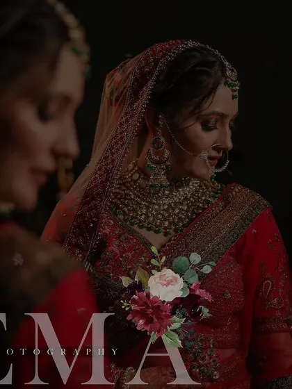 A moody and artistic bridal portrait with a reflection, creating a sense of depth and introspection. The dark tones and soft focus add to the photo's emotional quality.