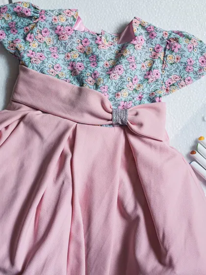 Another view of the floral and pink dress, showing the box pleats on the skirt that give it a lovely shape and volume.