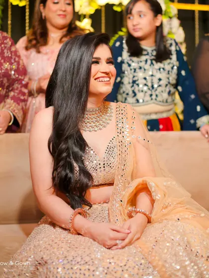 A candid shot of the bride-to-be laughing during her engagement party. Her genuine happiness and sparkling dress make this a lively and beautiful photo.