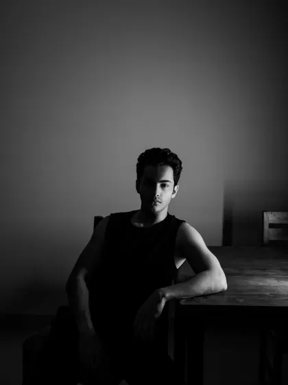 A minimalist black and white portrait using shadow and negative space. A simple, powerful shot for an actor's portfolio.