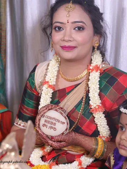 A lovely portrait of the bride holding a custom piece from her wedding. We focus on these personal details that make each wedding unique.