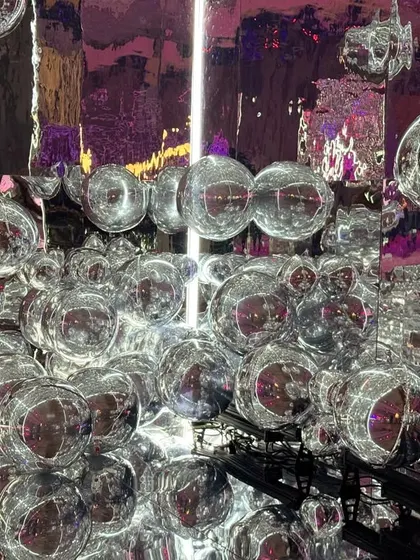 A close-up of the silver bubble installation. This walkway was designed to create a feeling of being in a world of funk and visual magic from the moment guests arrived.