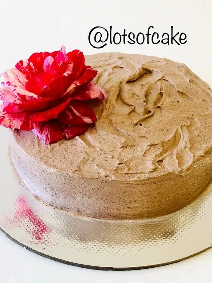 This is my butterscotch cake with a rustic chocolate frosting finish, decorated with a fresh rose from my garden. Simple, elegant, and delicious.