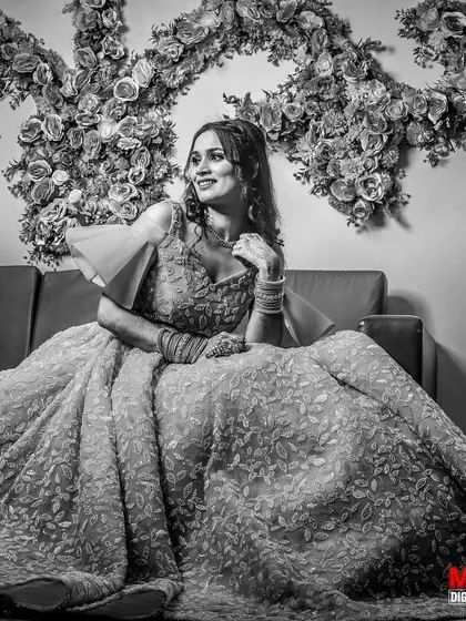 A stunning black and white portrait of the bride-to-be on her engagement, seated in her magnificent gown.