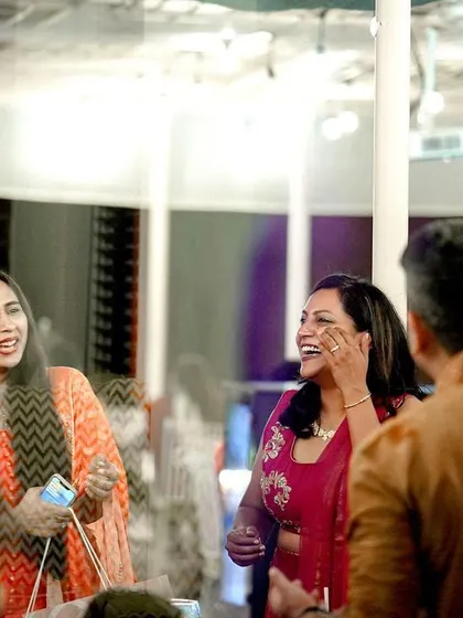 Guests enjoying the celebration, captured through a creative reflection, adding an artistic touch to the party photos.