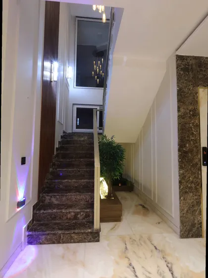 The staircase design incorporates a built-in planter, bringing a touch of nature indoors and balancing the hard materials with organic life.