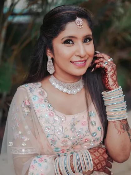 A close-up portrait of the bride-to-be, showcasing her stunning makeup, jewelry, and the intricate details of her engagement outfit.