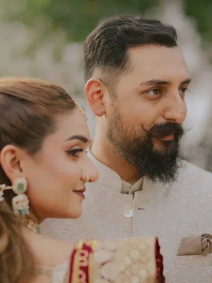 A classic, candid portrait. The bride's gentle gaze and the groom's quiet strength are beautifully captured in this close-up, showcasing the natural comfort they share.