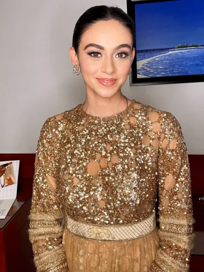 A close-up of a mesmerizing reception look, with shimmery gold eyeshadow that catches the light beautifully.