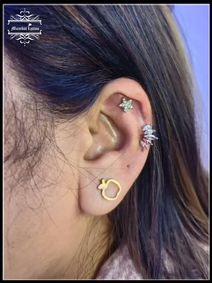 A mid-helix piercing featuring two beautiful studs. We have great offers on all needle piercings, so you can build the ear stack of your dreams.