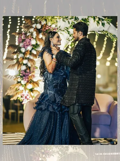 A romantic dance between the couple at their Sangeet. The beautiful floral arch and soft lighting create a dreamy atmosphere.